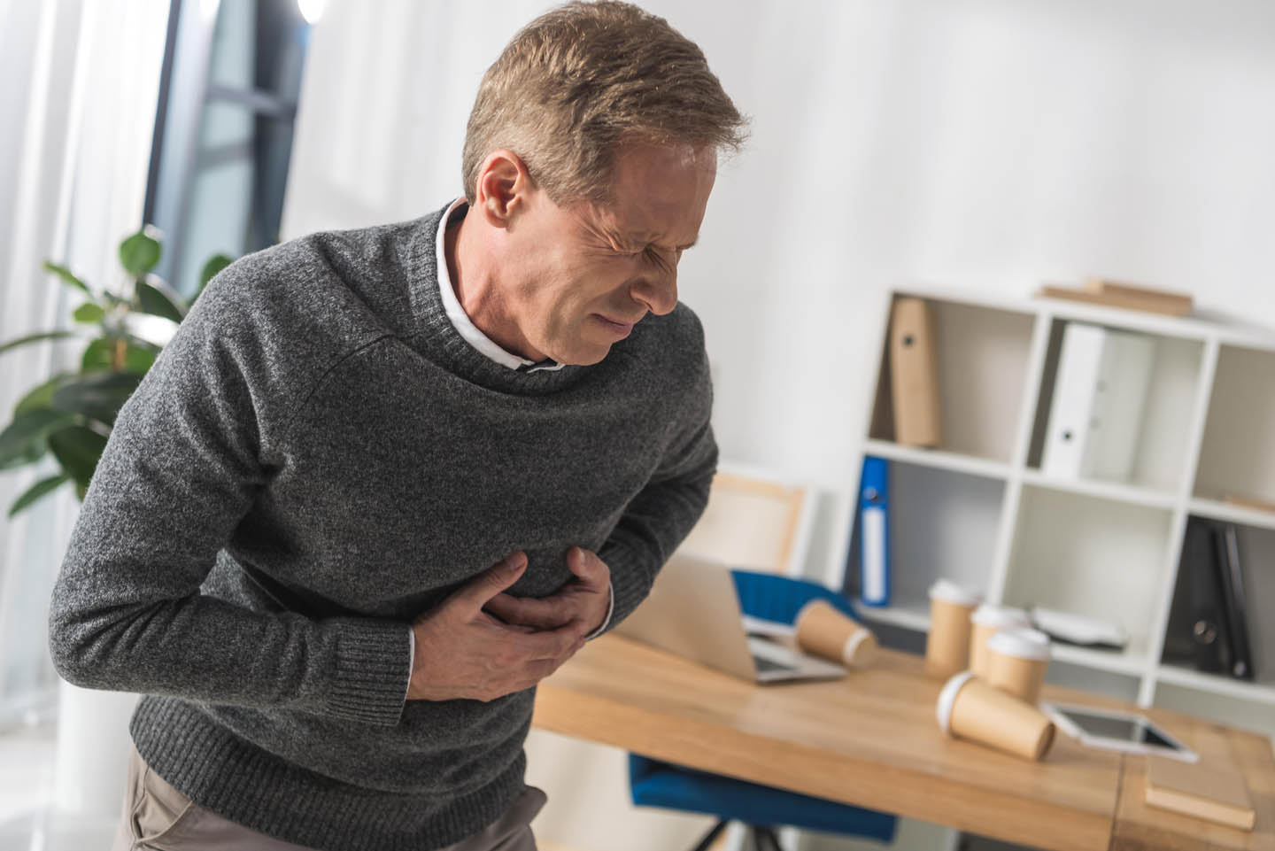 A man having a heart attack right in his office